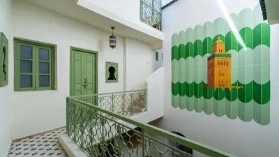 a staircase in a house with a painting on the wall at Riad Dar Tiflet in Marrakech