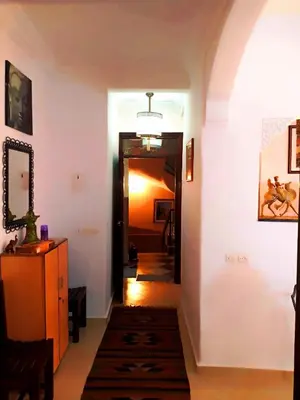 a hallway with a hallway leading into a room with a hallway at DAR AZIZ in Marrakech