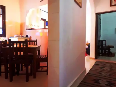 a kitchen and dining room with a table and chairs at DAR AZIZ in Marrakech