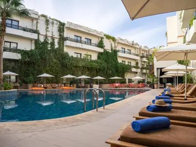 a pool at a hotel with chairs and umbrellas at Kech Boutique Hotel in Marrakech