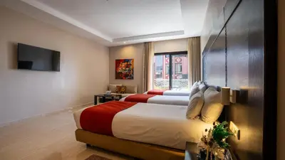 a hotel room with two beds and a television at Kech Boutique Hotel in Marrakech