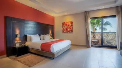 a bedroom with a large bed and a large window at Kech Boutique Hotel in Marrakech