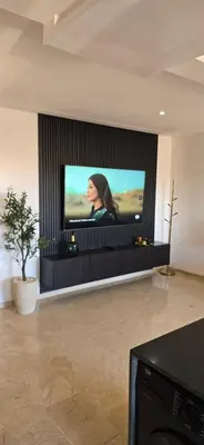 a flat screen tv on a wall in a living room at Luxueux appartement entre Gueliz et l'Hivernage avec WIFI in Marrakech