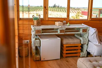 a room with a table and a refrigerator and a window at Le Parc des Oliviers Ecolodge in Marrakech