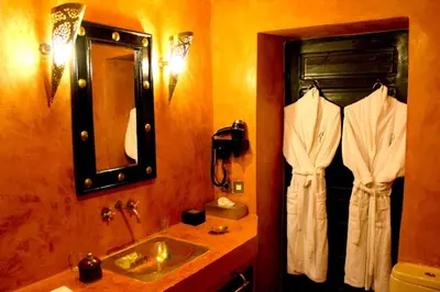 a bathroom with a sink and a mirror at Riad Hermès in Marrakech