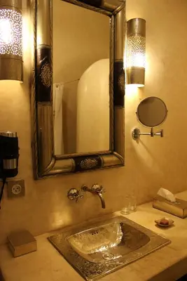 a bathroom with a sink and a mirror at Riad Hermès in Marrakech