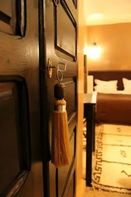 a tassel hanging from a door in a hotel room at Riad Hermès in Marrakech