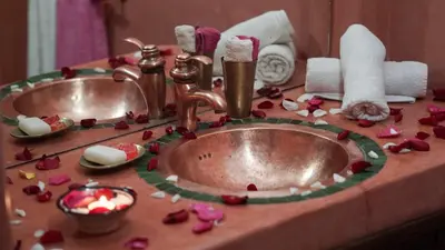 a bathroom sink with flowers on a counter at Riad Ahlsouss in Marrakech