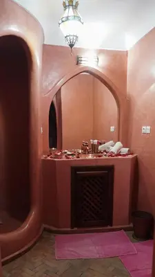 a bathroom with a large mirror and a fireplace at Riad Ahlsouss in Marrakech