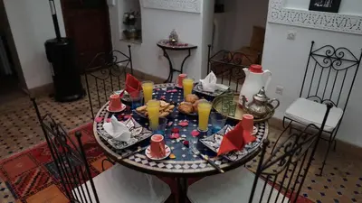 a table with food and drinks on top of it at Riad Ahlsouss in Marrakech