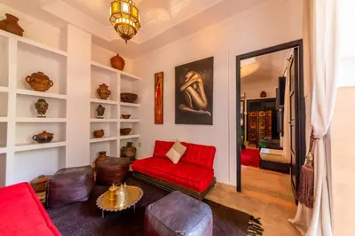 a living room with red furniture and a red couch at Riad Espoir, Riad de charme en exclusivité dans la médina de Marrakech in Marrakech