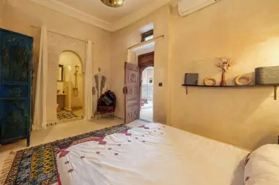 a bedroom with a large bed in a room at Riad 7 chambres - Petit dejeuner gratuit in Marrakech