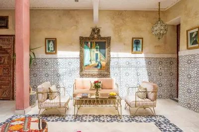 a living room with a couch and two chairs and a table at Riad 7 chambres - Petit dejeuner gratuit in Marrakech