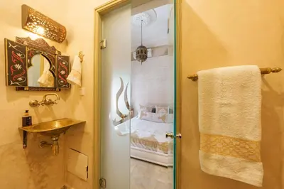 a bathroom with a shower with a sink and a toilet at Riad 7 chambres - Petit dejeuner gratuit in Marrakech