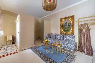 a living room with a couch and a table at Riad 7 chambres - Petit dejeuner gratuit in Marrakech