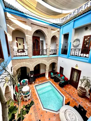 a large room with a swimming pool in a building at Riad Zarka By La Siredrah in Marrakech