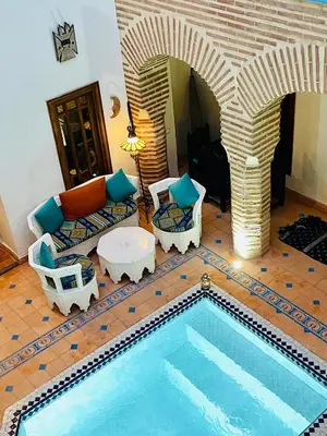 a living room with a swimming pool in a house at Riad Zarka By La Siredrah in Marrakech