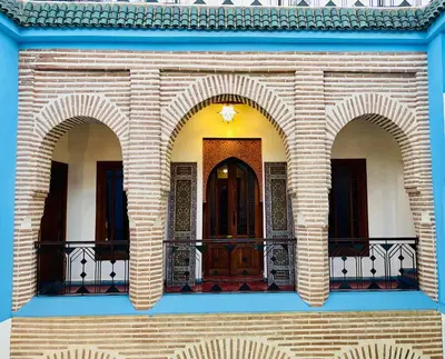 a building with two arched windows and a balcony at Riad Zarka By La Siredrah in Marrakech