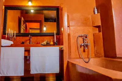 a bathroom with a shower and a sink with towels at Riad Zarka By La Siredrah in Marrakech
