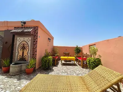 an outdoor patio with a yellow table and chairs at Cosy appartement in Marrakech
