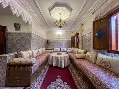 a living room with a couch and a table at Cosy appartement in Marrakech