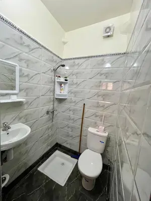 a bathroom with a toilet and a sink at Cosy appartement in Marrakech