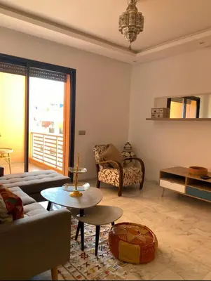 a living room with a couch and a table at Appartement avec terrasse au calme en plein centre de Marrakech tres rare in Marrakech