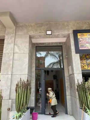 a woman is standing outside of a building at Appartement avec terrasse au calme en plein centre de Marrakech tres rare in Marrakech