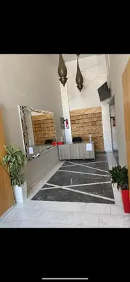 an empty room with two potted plants in a building at Appartement avec terrasse au calme en plein centre de Marrakech tres rare in Marrakech