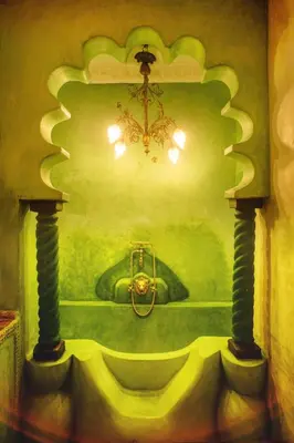 a painting of a green bathroom with a chandelier at Riad Persephone in Marrakech