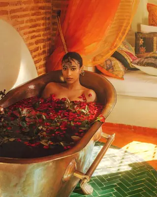 a woman sitting in a tub full of flowers at Riad Persephone in Marrakech