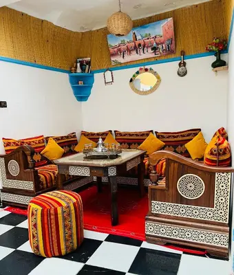 a living room with couches and a table at Dar Beldi in Marrakech