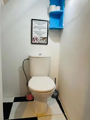 a bathroom with a toilet with a sign on the wall at Dar Beldi in Marrakech