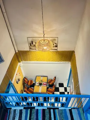 a living room with a couch and a chandelier at Dar Beldi in Marrakech
