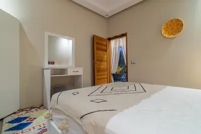 a bedroom with a bed and a mirror on the wall at VILLA MARIA - Famille uniquement in Marrakech