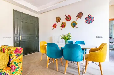 a dining room with a table and blue chairs at VILLA MARIA - Famille uniquement in Marrakech