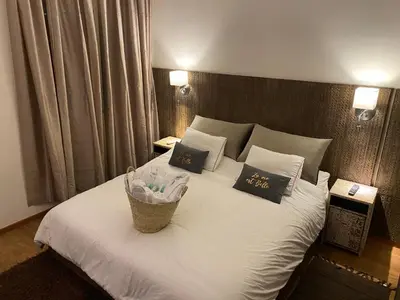 a bedroom with a white bed with a basket on it at Appartment Rhizlane in Marrakech