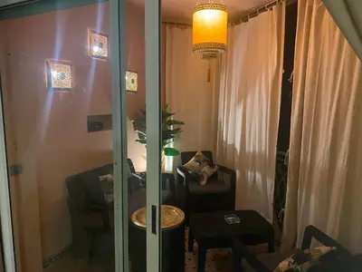 a room with a room with a table and a mirror at Appartment Rhizlane in Marrakech