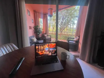 a laptop sitting on a table in a room with a window at Appartment Rhizlane in Marrakech