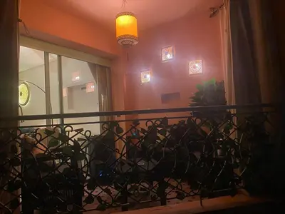 a balcony with a fence and a window and a light at Appartment Rhizlane in Marrakech