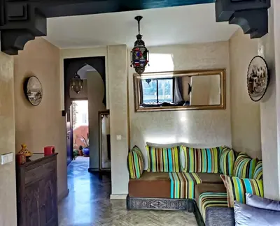 a living room with a couch and a mirror at La Perle de l'Atlas by Golf Resort in Marrakech