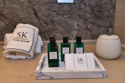 a group of four bottles of skincare on a table at Appartement de prestige climatisé à l'hivernage 400m de la Gare in Marrakech