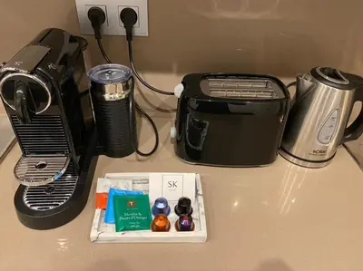 a counter top with a toaster and a box of candy at Appartement de prestige climatisé à l'hivernage 400m de la Gare in Marrakech