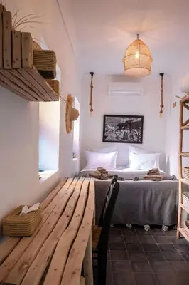 a bedroom with a bed and a wooden table at Riad Darsahalia in Marrakech