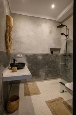 a bathroom with a sink and a glass shower at Riad Darsahalia in Marrakech