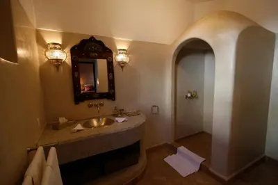 a bathroom with a sink and a mirror at Riad Assakina in Marrakech