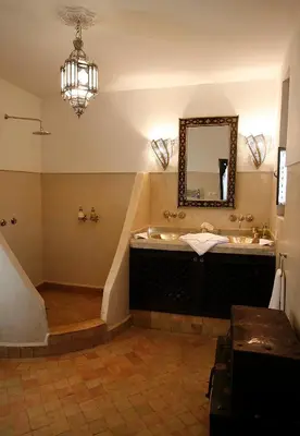 a bathroom with a sink and a mirror at Riad Assakina in Marrakech