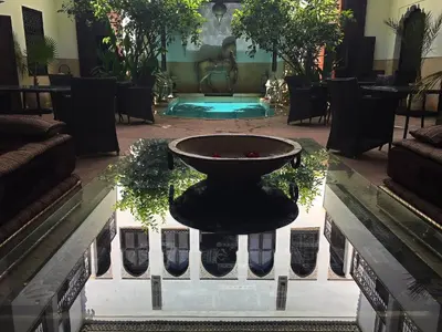 a fountain in the middle of a room at Riad Assakina in Marrakech