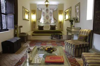a living room with a couch and a bed at Riad Assakina in Marrakech