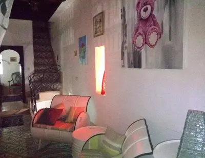 a living room with two chairs and a couch at Riad Gaya in Marrakech